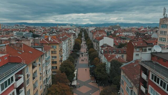 High drone footage of Vitosha Boulevard with St. Nedelya Church in the distance in Sofia, Bulgaria
