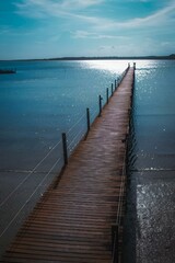 Fototapeta premium a pier that looks very long over the water, and has no boats