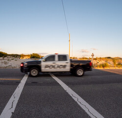 a truck drives down the street with a light on it