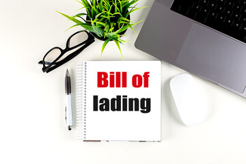 BILL OF LADING text on notebook with laptop, mouse and pen