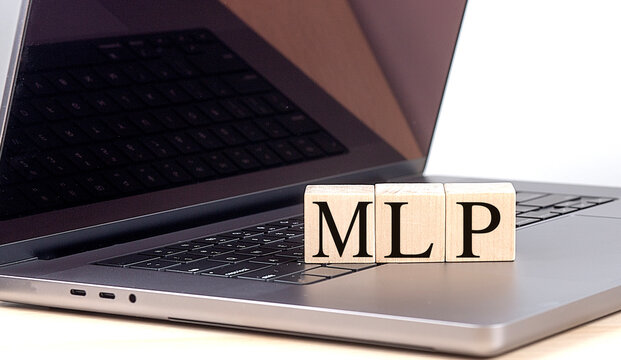 MLP word on wooden block on a laptop , business concept