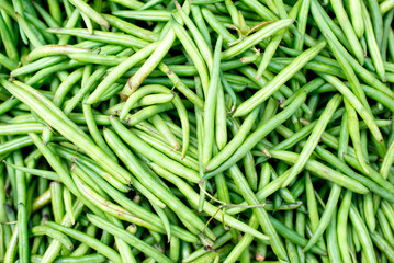 the green beans are piled together on the table closeup