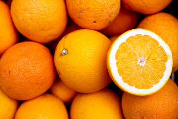 a lemon cut in half is sitting among other citruss