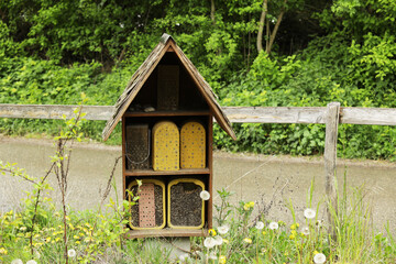 A hotel, insect building or bee hotel in a park, a refuge for insects of various shapes, sizes and...
