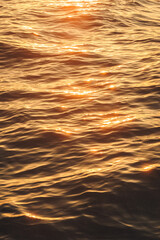 the sun is setting over water in the background of a clear sky