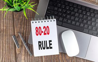 80-20 RULE text on notebook with laptop, mouse and pen