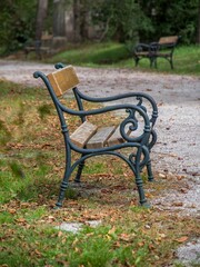 Wooden bench situated in the middle of a grassy field.