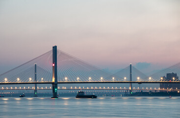 Illuminated Wuhan Yangtze River Second Bridge at dawn.