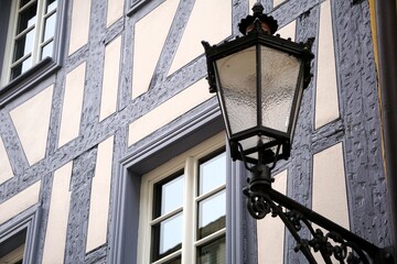 there is a street light and the building has beautiful windows