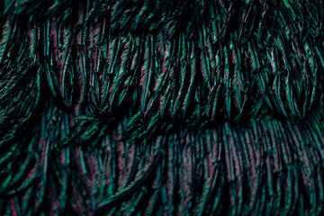 Closeup shot of dark greenish feathers creating a beautiful natural pattern
