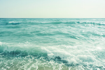 Photo of minimalistic light blue sea water with small waves in a pastel aesthetic style with simple neutral colors as an aesthetic background