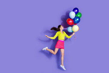 Photo of charming funny lovely cheerful girl wear stylish clothes hold balloons isolated on purple color background