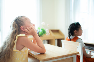 Teacher and students, Learn and study in a classroom of school where youngsters sit and listen attentively.
