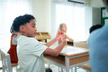 Teacher and students, Learn and study in a classroom of school where youngsters sit and listen attentively.