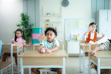 Students learn and study in a classroom of school where youngsters sit and listen attentively.