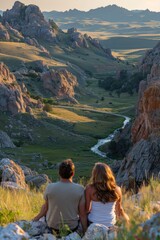 Naklejka premium A young couple pauses during their road trip to admire a breathtaking scenic mountain view, sitting together and enjoying the picturesque landscape.