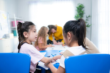 Fototapeta premium Teacher and students, Learn and study in a classroom of school where youngsters sit and listen attentively.