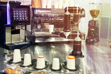 Robot with artificial intelligence making coffee on coffee machine