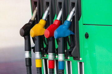 Petrol station with colored guns and fuel hoses. Gasoline, diesel, eco hydrogen refueling column.. Close-up