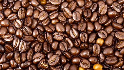 Fototapeta premium Roasted coffee beans background. Top view. Coffee background for coffee business cafe coffee shop