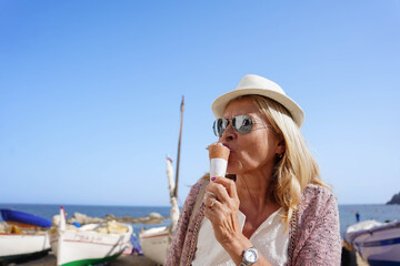 happy old woman eating ice cream in summer holidays. sugar sweet