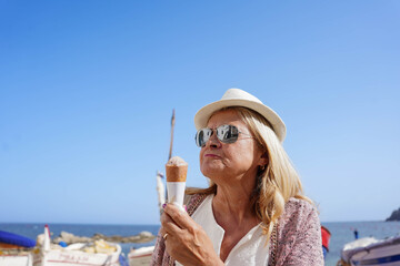 summery woman with sunglasses eating ice cream in summertime