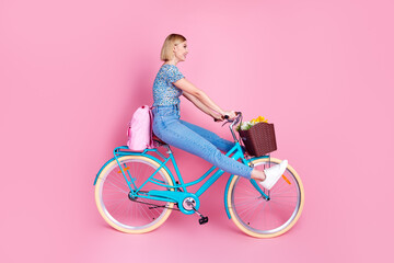 Full size profile photo of pretty young girl bike wear top isolated on pink color background