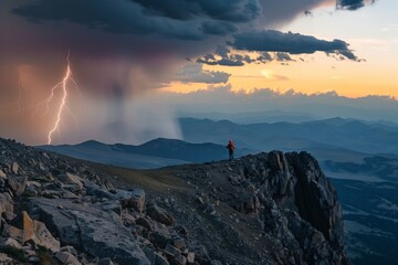 A hiker stands on a rocky mountain ridge, witnessing a dramatic sunset with storm clouds and a lightning bolt striking the distant landscape.