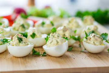 stuffed eggs, deviled eggs on a wooden table