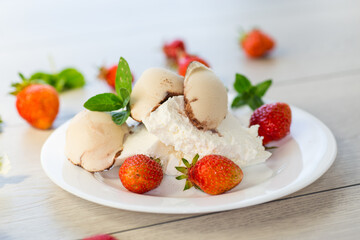 fresh organic cottage cheese with strawberries and ice cream in a plate on a wooden table