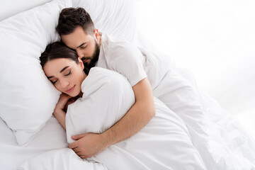 Fototapeta premium Photo of charming pretty boyfriend girlfriend sleepwear hugging having nap indoors home bedroom