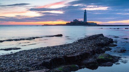 Sunrise over St Mary's Lighthouse and island at Whitley Bay on the north east coast of England, UK.