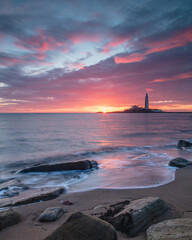 Sunrise over St Mary's Lighthouse and island at Whitley Bay on the north east coast of England, UK.