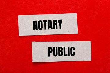 Notary public words written on paper pieces with red background. Conceptual notary public symbol....