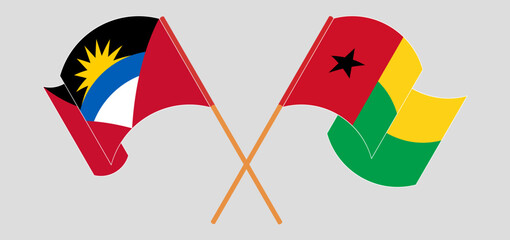 Crossed and waving flags of Antigua and Barbuda and Guinea-Bissau