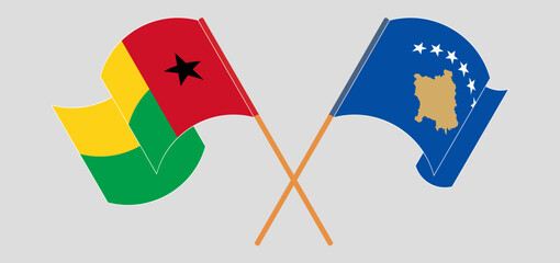Crossed and waving flags of Guinea-Bissau and Kosovo