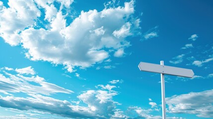 Empty signpost against a blue sky with clouds