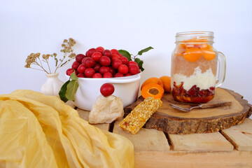 fresh juice fruit and berry low-calorie mousse, dessert in glass with bubble tea, ripe apricots, cherry plums, pears, muesli bar, concept of healthy eating, vegan diet, raw food, healthy food