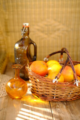 ripe apples in basket, apple juice, bottle of cider, rustic table flooded with warm sunlight,...