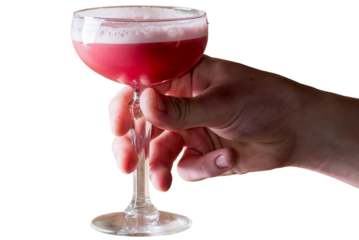 Hand is holding a pink cocktail in a tall glass