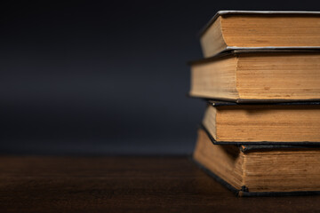 Book stack in the library room on dark background for business and education background, back to...