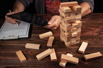 Planning, risk and strategy in business, businessman and engineer gambling placing wooden block on...