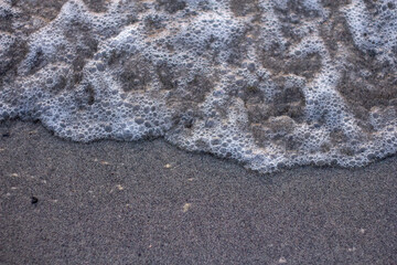 A closeup photo of ocean waves at the shoreline