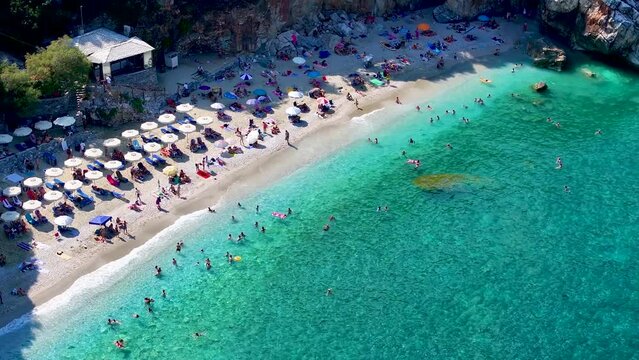 Aerial view of the popular beach of Milopotamos, North Pelion Coast, Greece, with emerald and turquoise sea