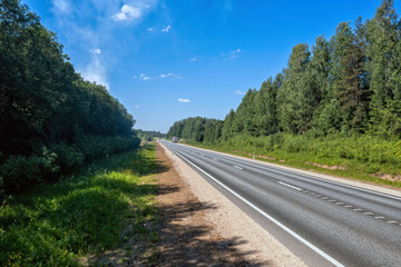 Tranquil Road With Trees and Blue Sky