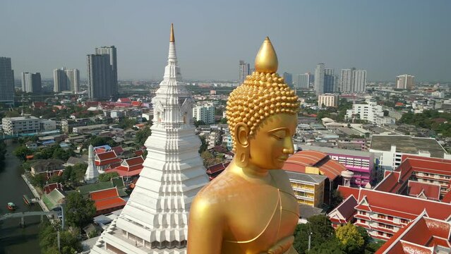 Aerial view of the Giant Golden Buddha in Bangkok and a city skyline