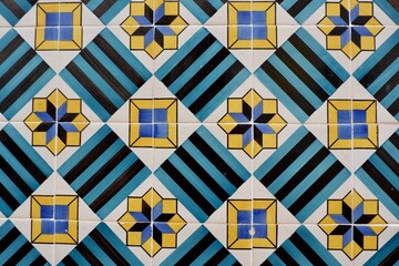 Vintage vibrant tiles with geometrical lined ornate in Lisbon, Portugal. Old fashioned tiled wall