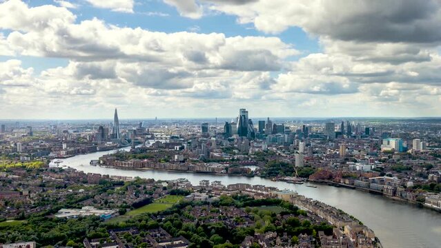 Wide panoramic time lapse view of the London skyline along the river Thames from London Bridge until the City during a sunny summer day, United Kingdom 