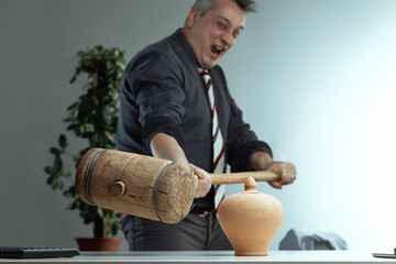 Gray-haired man enthusiastically swings mallet, playful expressi