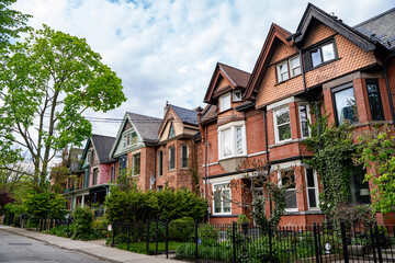 Street with narrow Victorian semi detached houses in Toronto.